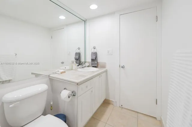 a bathroom with a sink toilet vanity and shower