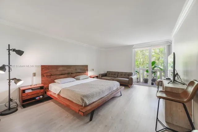 a bedroom with a bed window and couch