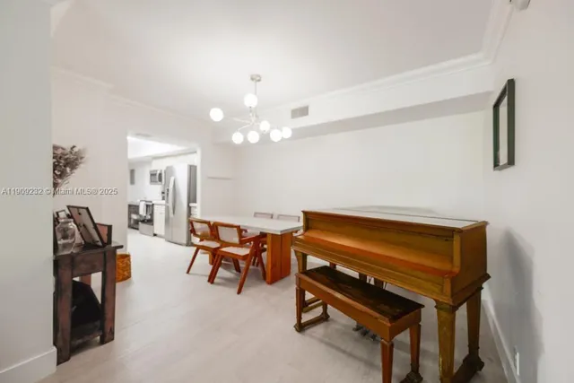 a room with gym equipment and wooden floor