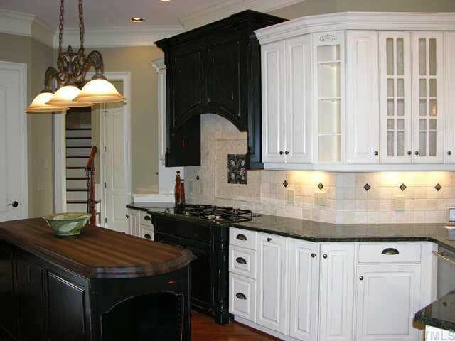 9020 Chelsea Drive Raleigh, NC 27603 - Photo 5 of 10 a kitchen with stainless steel appliances granite countertop a sink a stove and a wooden cabinets