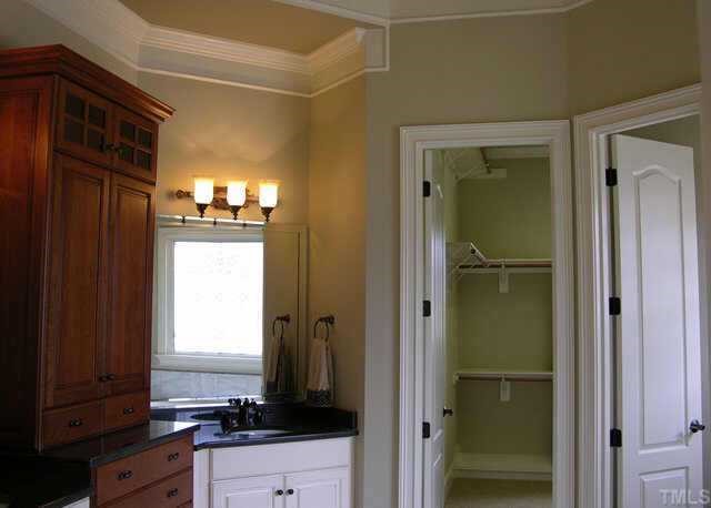 9020 Chelsea Drive Raleigh, NC 27603 - Photo 8 of 10 a bathroom with a sink and a mirror