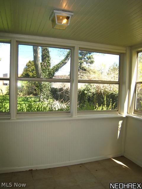 3541 Lytle Road Beachwood, OH 44122 - Photo 5 of 20 Enclosed porch with ceramic floor and wall of windows overlooking the fenced rear yard.