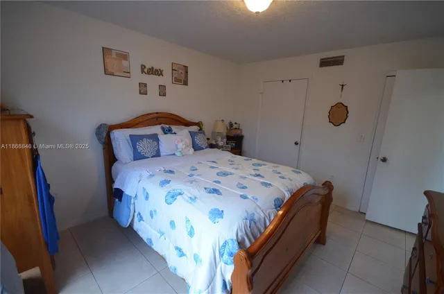 a bedroom with a bed and a mirror