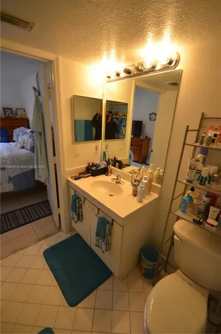 a bathroom with a sink mirror vanity and toilet