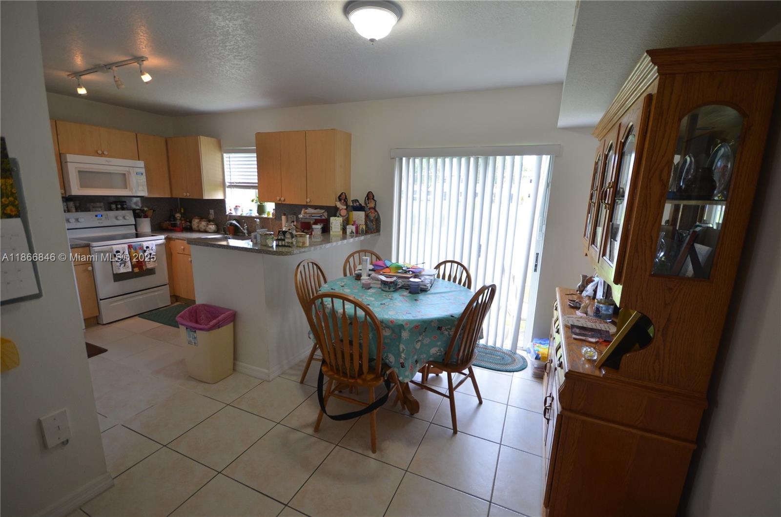 1270 Southeast 27th Street, Unit 101 Homestead, FL 33035 - Photo 24 of 32 a view of a dining room with furniture and a chandelier