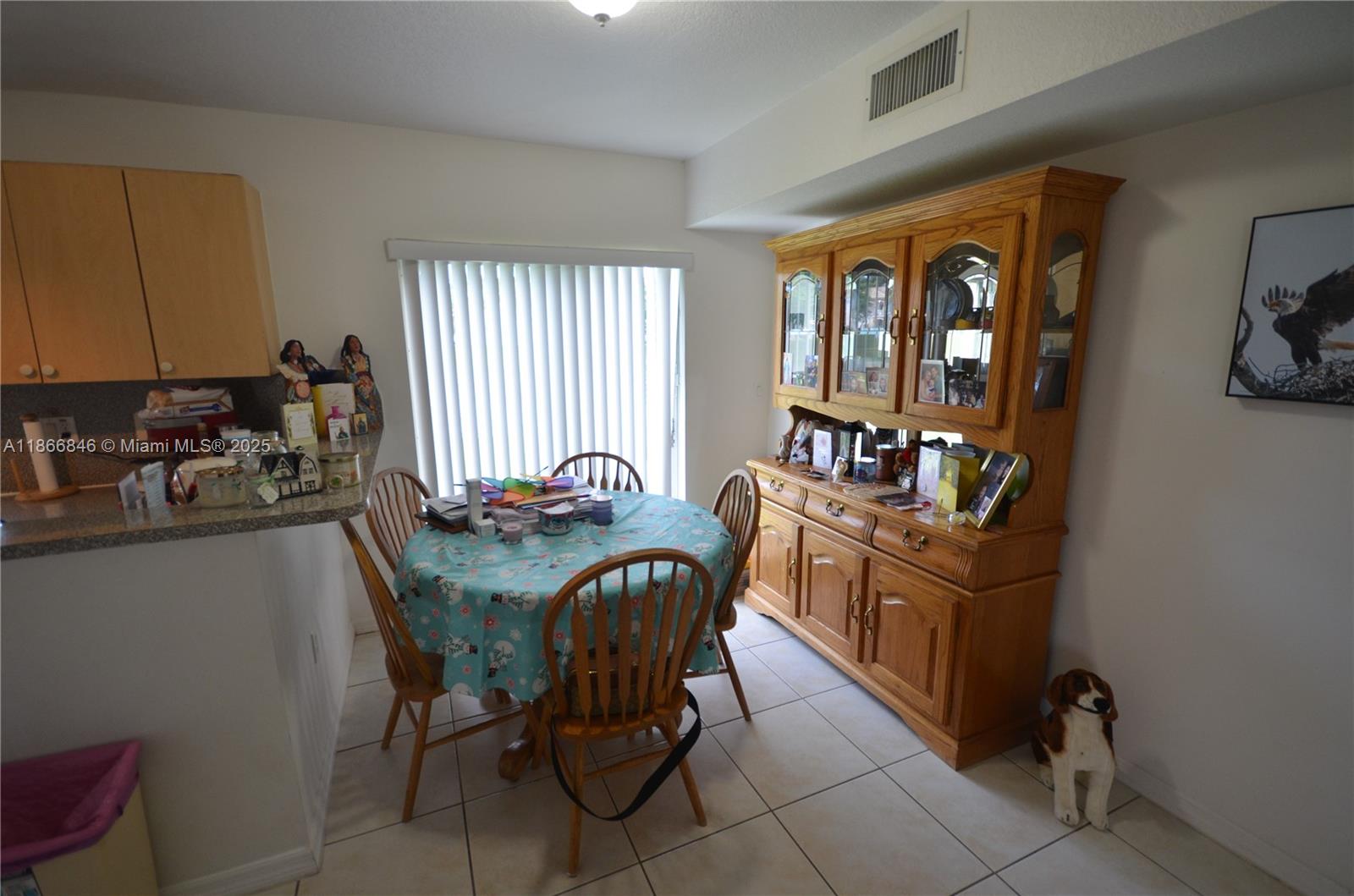 1270 Southeast 27th Street, Unit 101 Homestead, FL 33035 - Photo 25 of 32 a view of a dining room with furniture and window