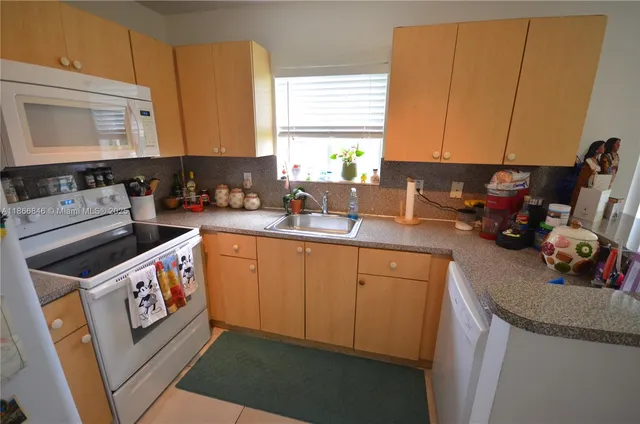 a kitchen with a sink stove and cabinets