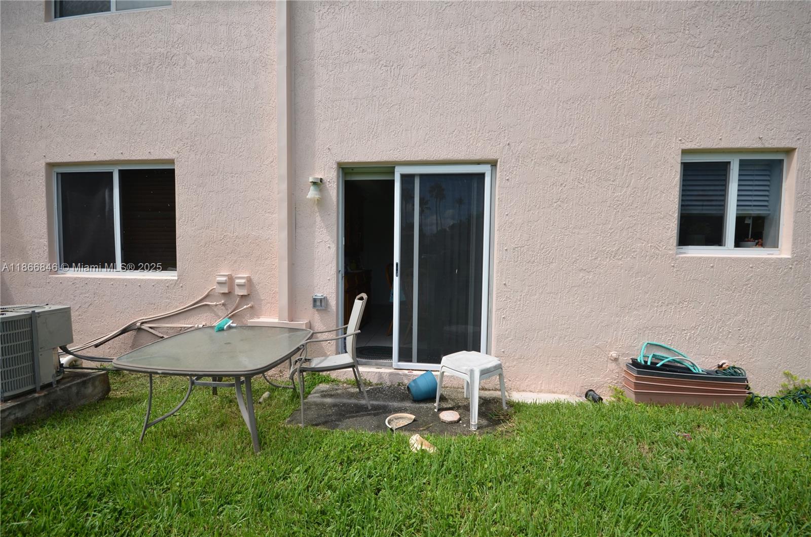 1270 Southeast 27th Street, Unit 101 Homestead, FL 33035 - Photo 31 of 32 a backyard of a house with table and chairs