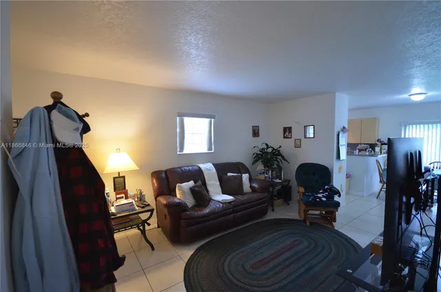 a living room with furniture a rug and a window