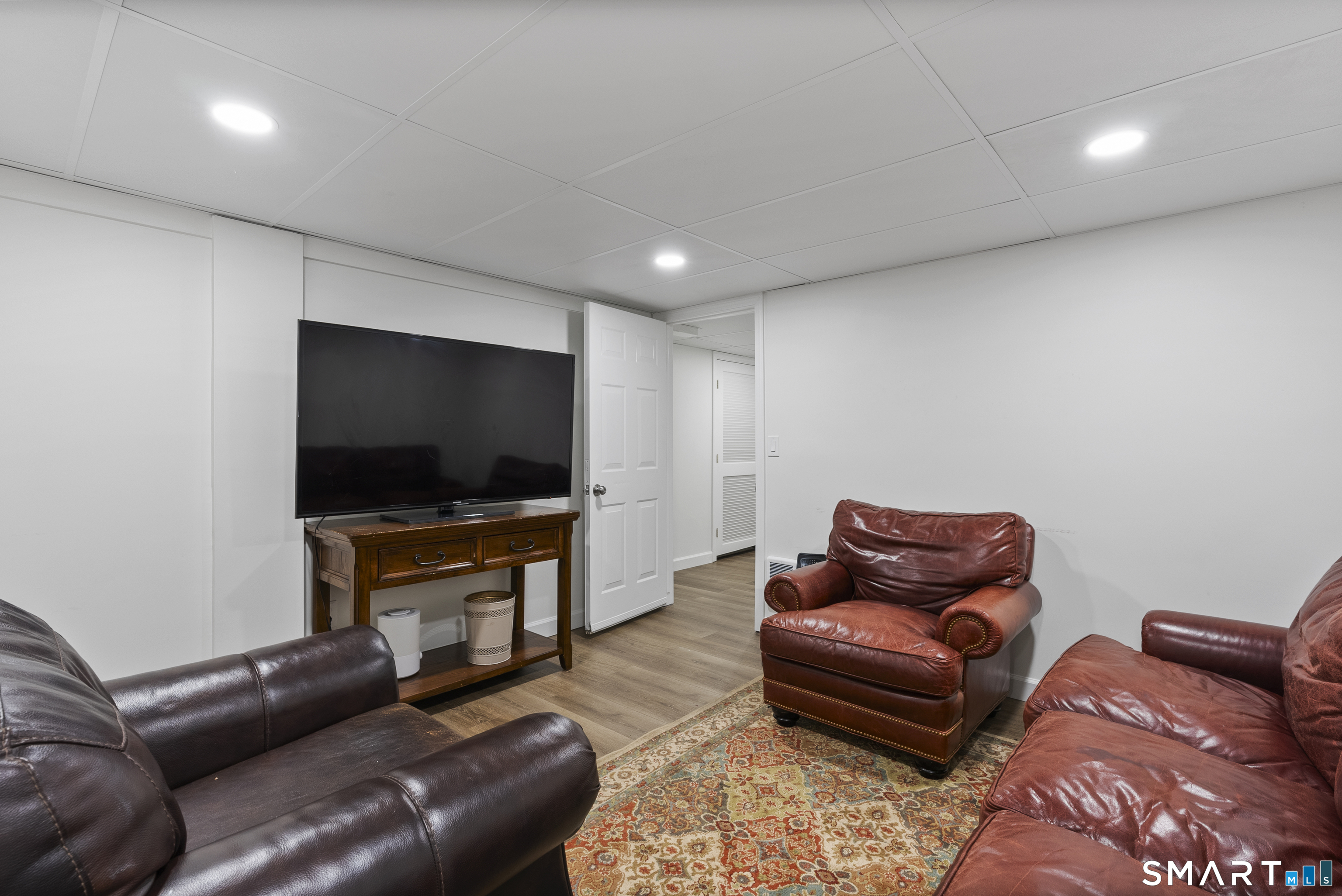 44 Farmstead Lane Suffield, CT 06078 - Photo 28 of 39 a living room with furniture and a flat screen tv