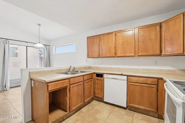 a view of kitchen with refrigerator stove microwave and cabinets
