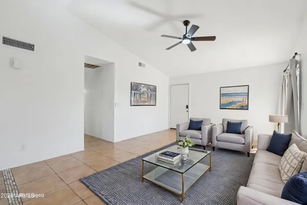a view of a livingroom with a ceiling fan and window