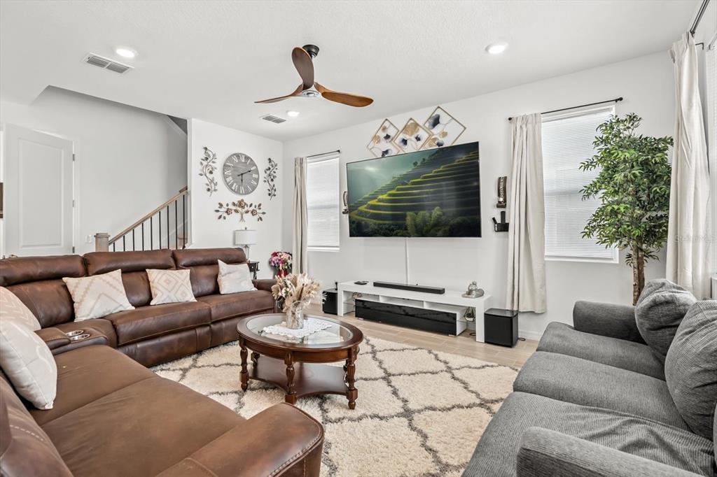 17061 Seville Orange Road Winter Garden, FL 34787 - Photo 12 of 42 a living room with furniture and a flat screen tv