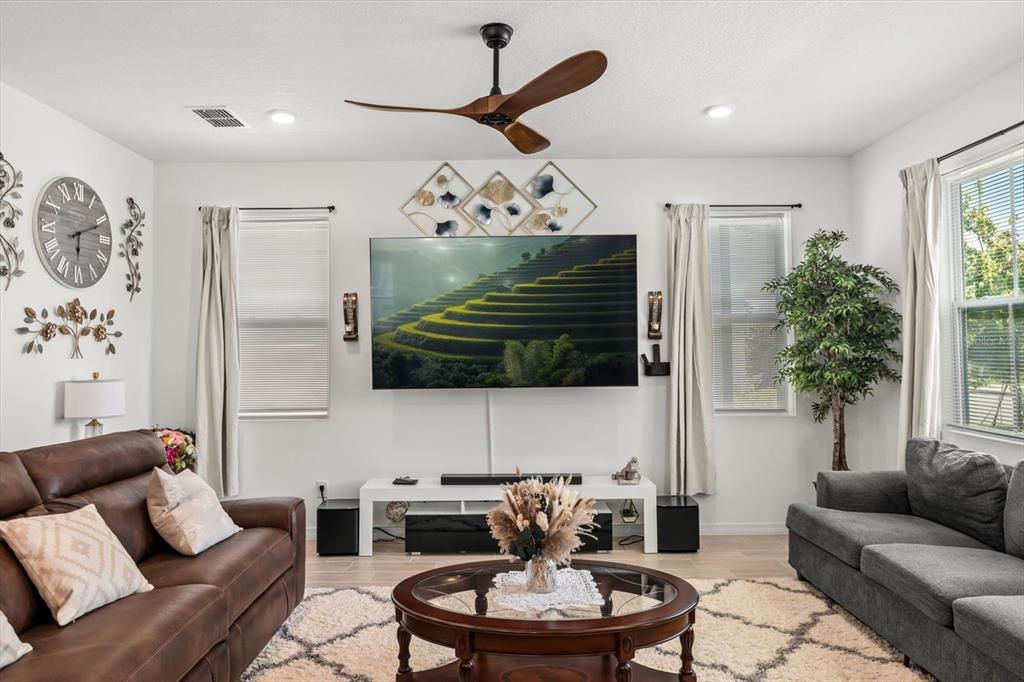 17061 Seville Orange Road Winter Garden, FL 34787 - Photo 13 of 42 a living room with furniture and a fireplace