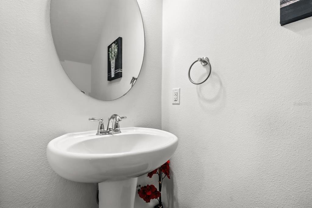 17061 Seville Orange Road Winter Garden, FL 34787 - Photo 15 of 42 a bathroom with a sink and mirror