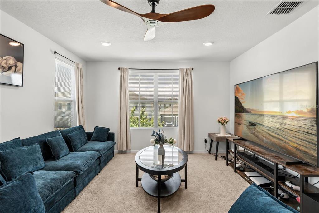 17061 Seville Orange Road Winter Garden, FL 34787 - Photo 22 of 42 a living room with furniture and a flat screen tv
