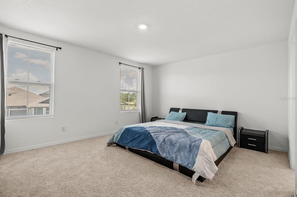 17061 Seville Orange Road Winter Garden, FL 34787 - Photo 23 of 42 a bedroom with a bed and a window