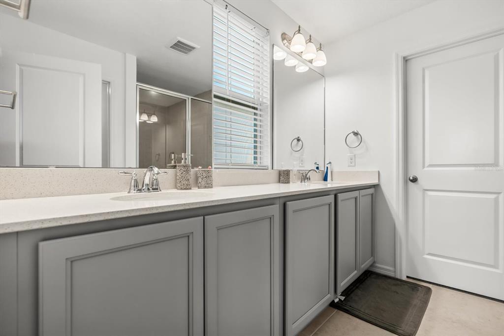 17061 Seville Orange Road Winter Garden, FL 34787 - Photo 25 of 42 a bathroom with a double vanity sink and a mirror