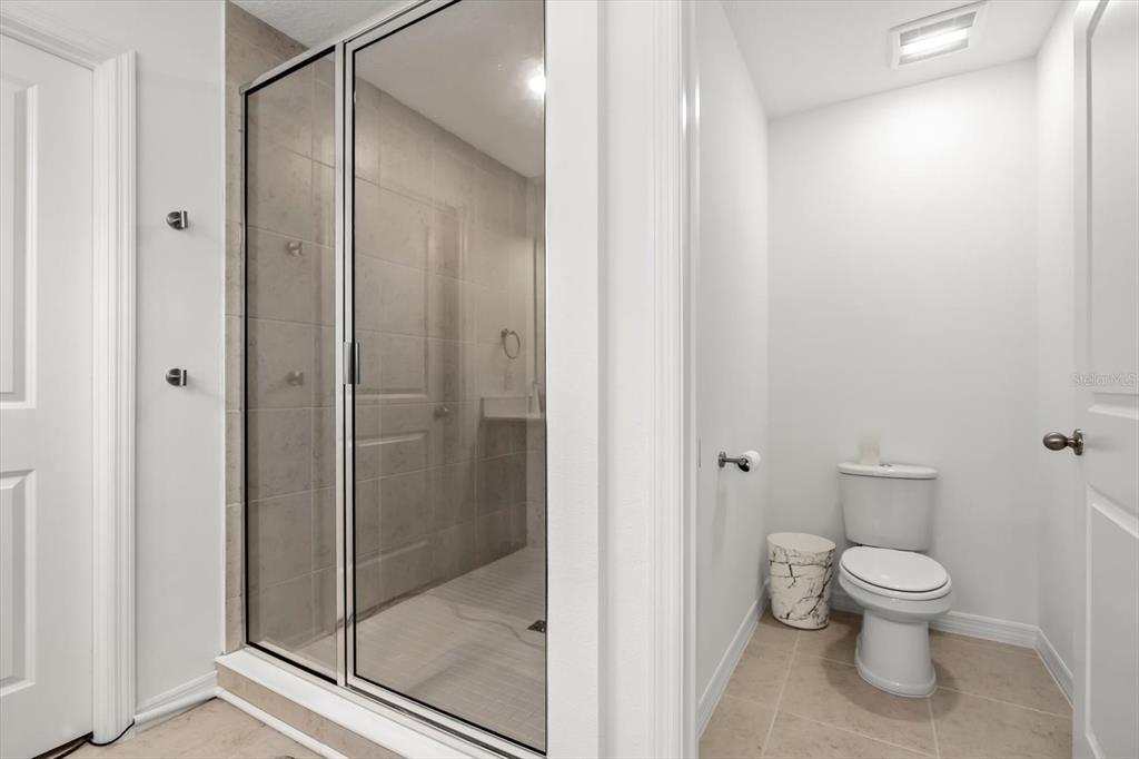 17061 Seville Orange Road Winter Garden, FL 34787 - Photo 26 of 42 a bathroom with a toilet and a shower