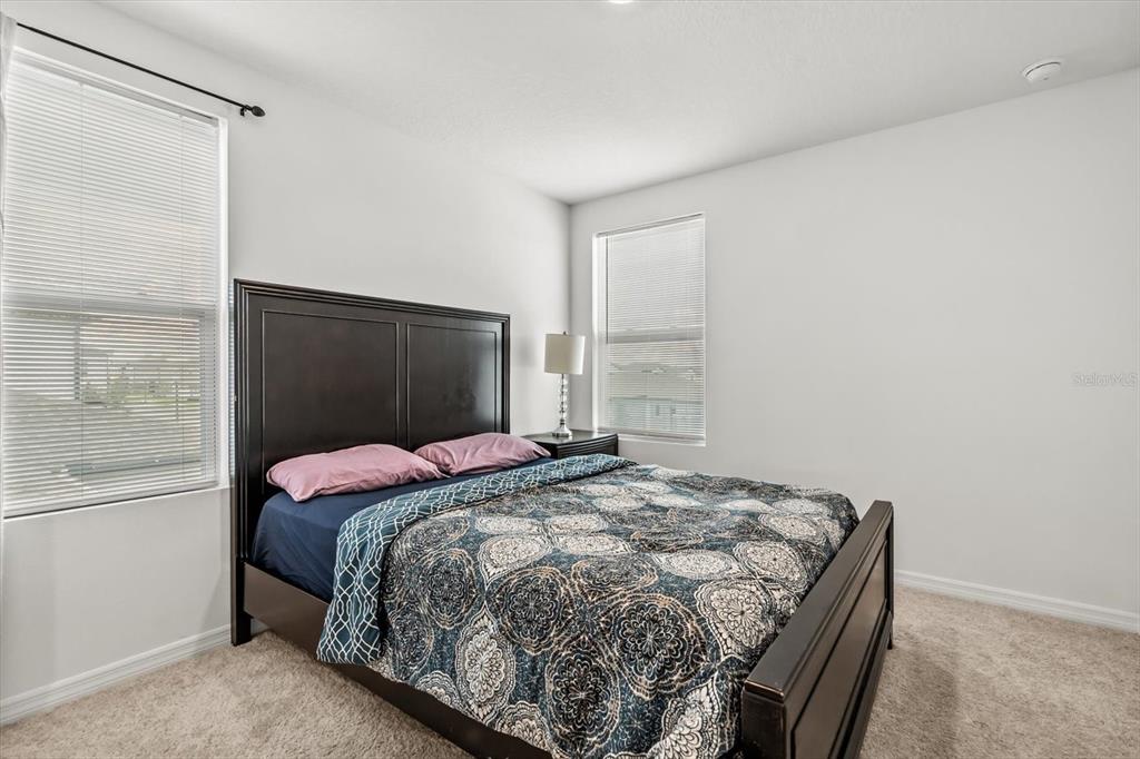 17061 Seville Orange Road Winter Garden, FL 34787 - Photo 29 of 42 a bedroom with a bed and a dresser