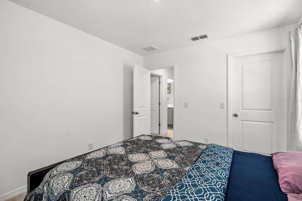 17061 Seville Orange Road Winter Garden, FL 34787 - Photo 30 of 42 a bedroom with a bed and wooden floor