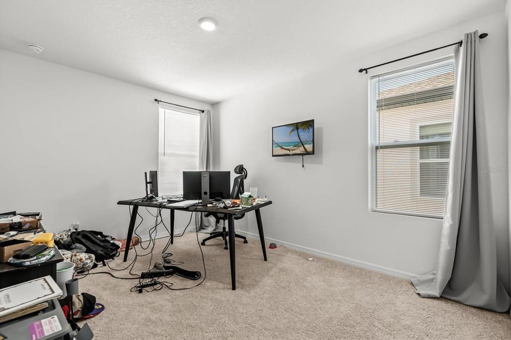 17061 Seville Orange Road Winter Garden, FL 34787 - Photo 31 of 42 a view of a workspace with furniture and a window
