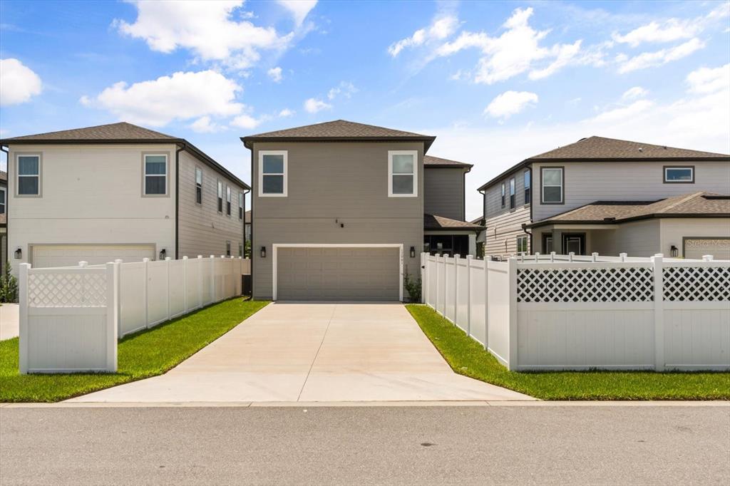 17061 Seville Orange Road Winter Garden, FL 34787 - Photo 40 of 42 a front view of a house with a yard and garage