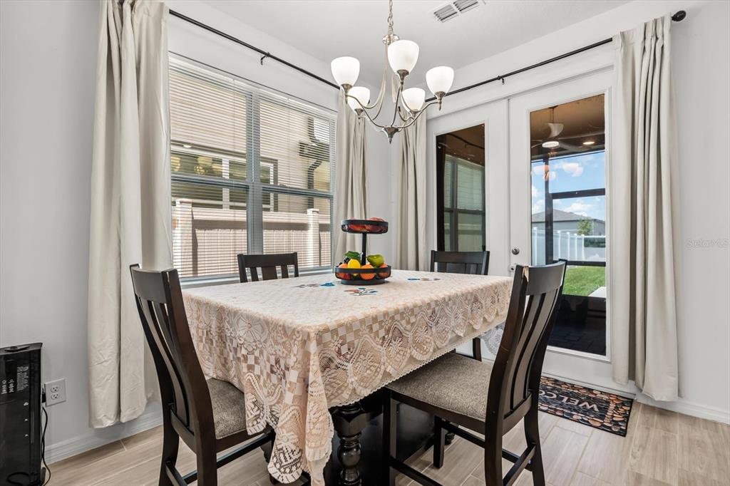 17061 Seville Orange Road Winter Garden, FL 34787 - Photo 9 of 42 a view of a dining room with furniture window and wooden floor