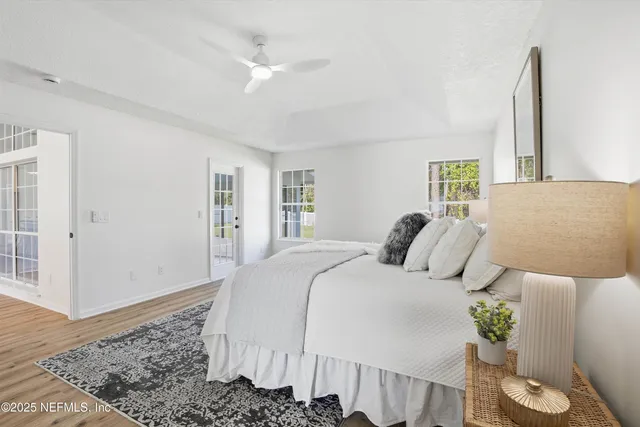 a bedroom with a large bed and a chandelier