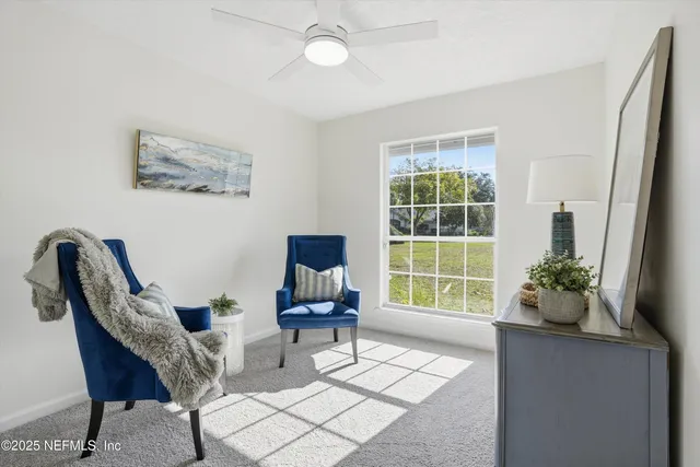 a living room with furniture and a potted plant