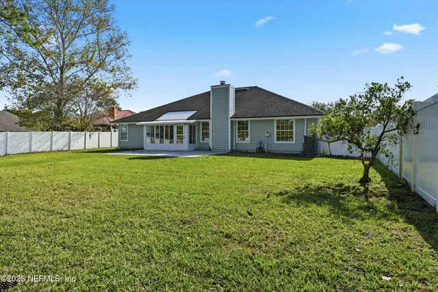 a view of a house with a yard and sitting area