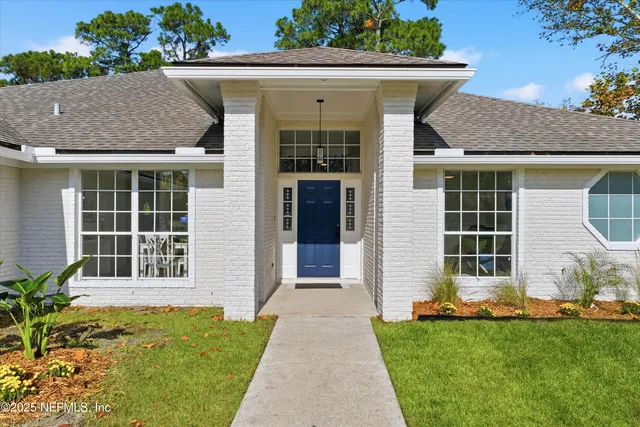 a front view of a house with a garden