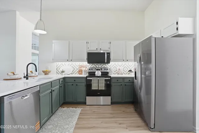 a kitchen with stainless steel appliances granite countertop a refrigerator and a stove top oven
