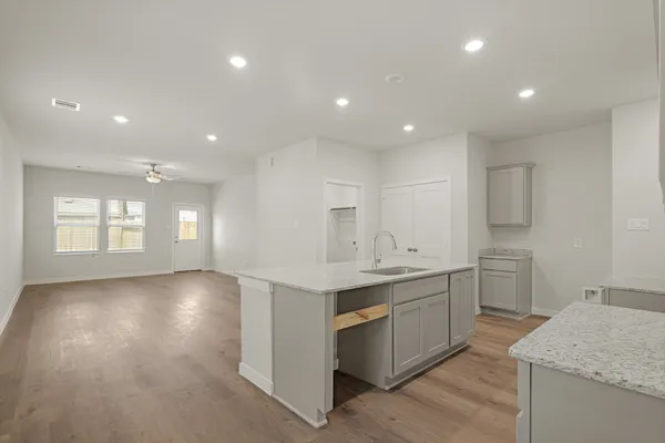 a kitchen with a sink stove and cabinets