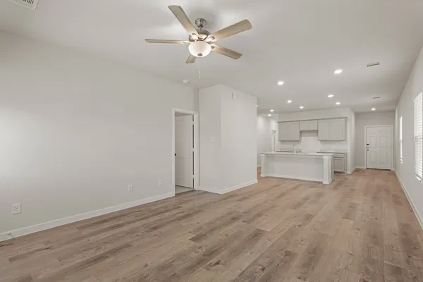 a view of an empty room with a kitchen