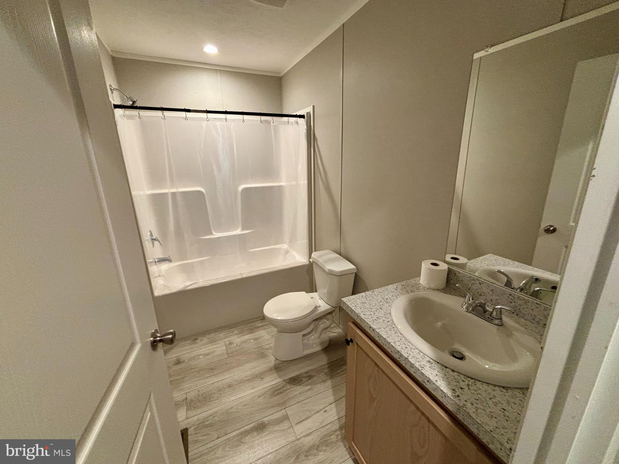12623 Shell Mill Road, Unit 124 Bishopville, MD 21813 - Photo 8 of 10 a bathroom with a sink and a mirror