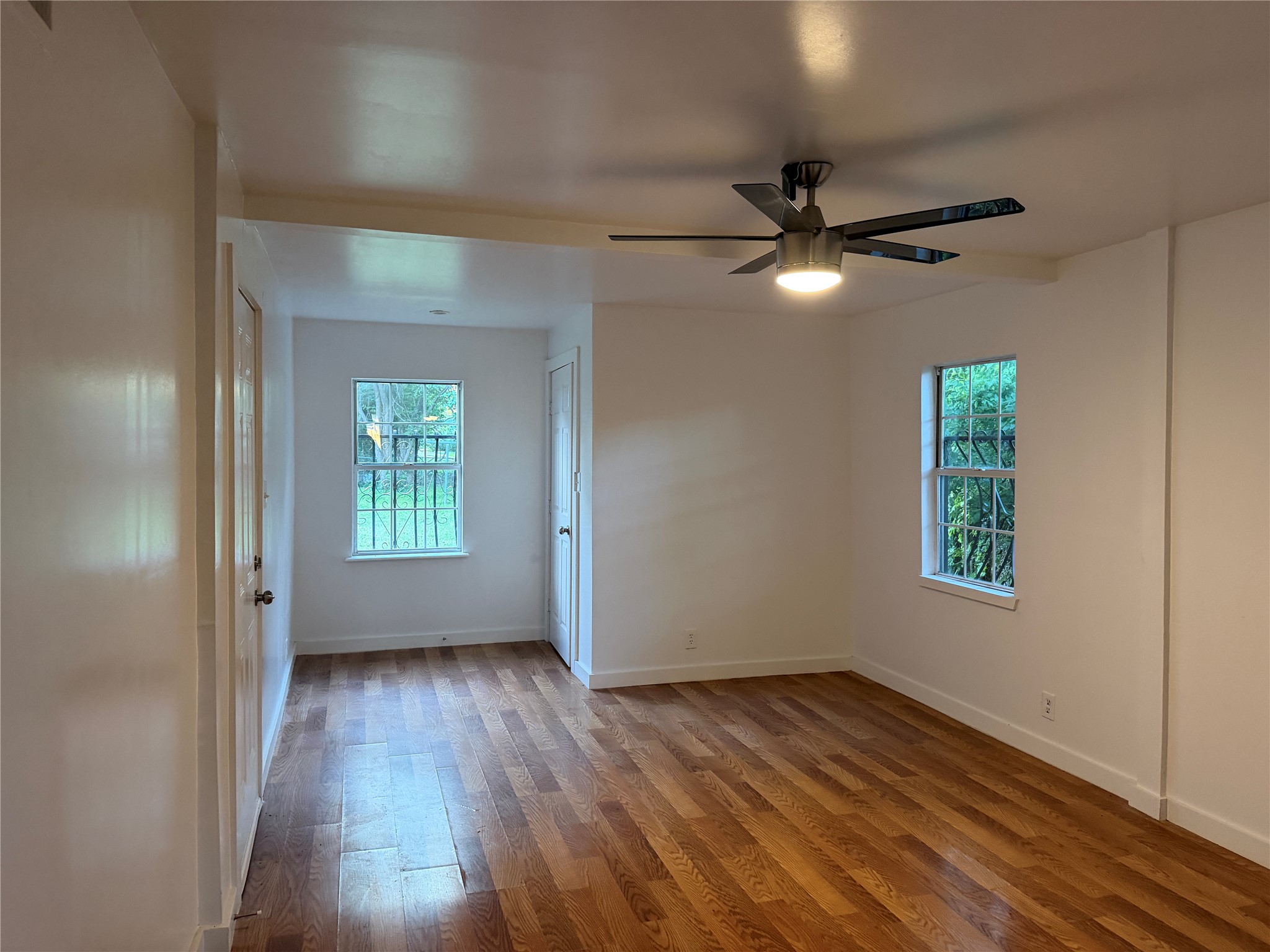 1060 Gardner Road Austin, TX 78721 - Photo 10 of 19 Naturally illuminated interiors boast gleaming wood flooring, creating an inviting atmosphere.