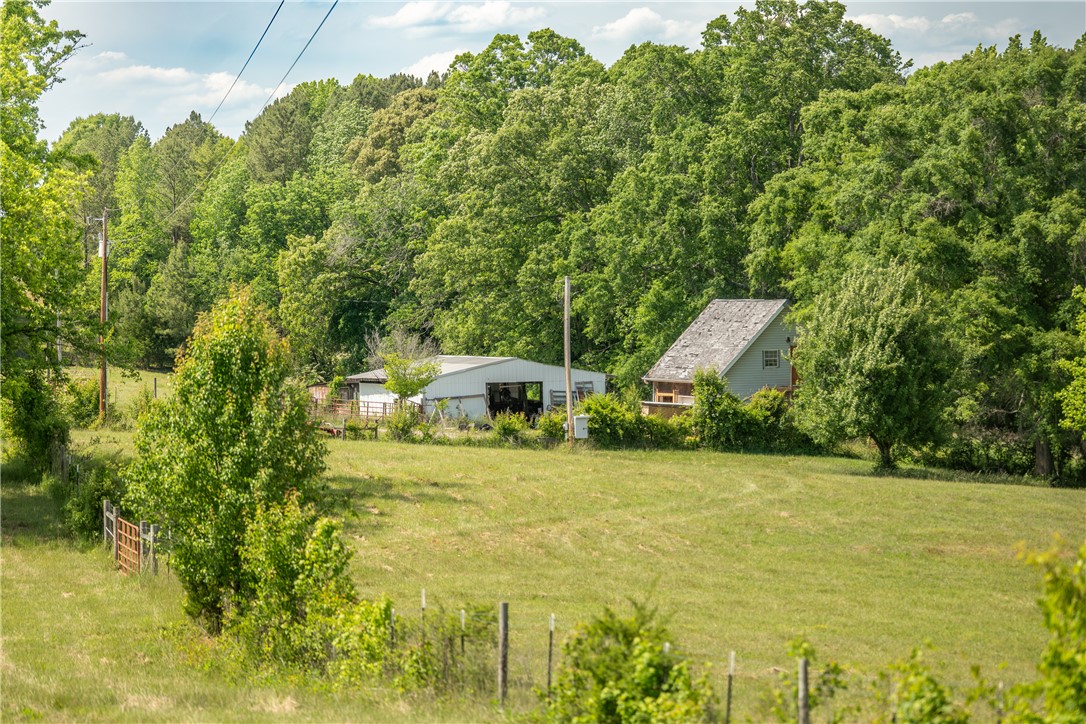 This tranquil property features a charming home nestled in a lush, green landscape.