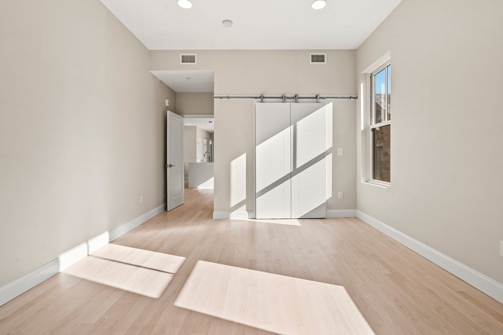 124 Warren Street, Unit 202 Boston, MA 02119 - Photo 11 of 23 a view of entryway and hall with wooden floor