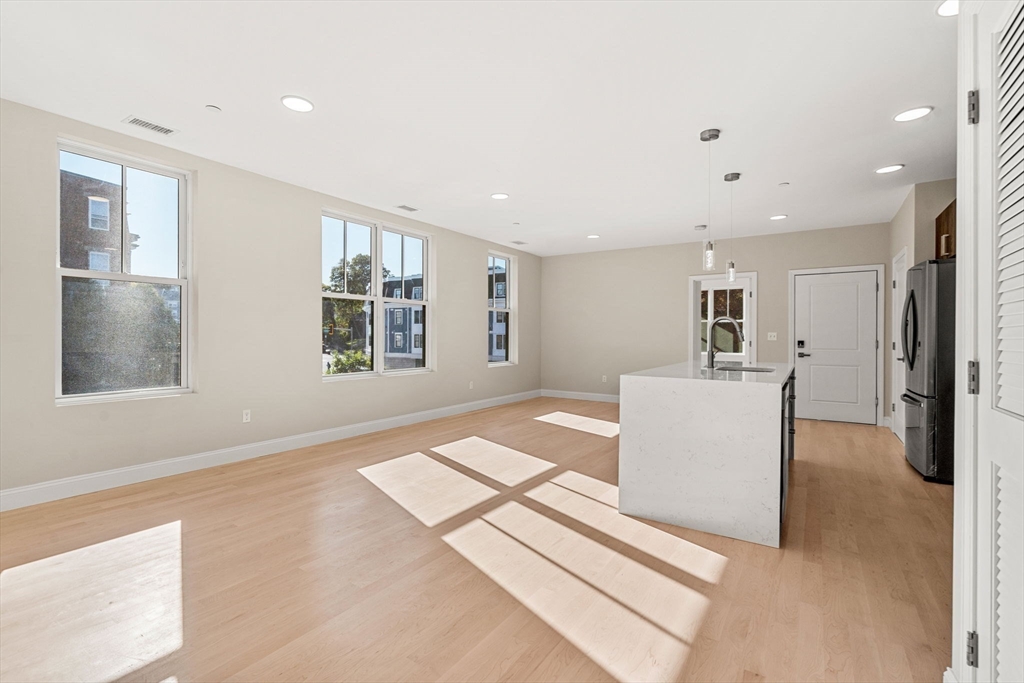 124 Warren Street, Unit 202 Boston, MA 02119 - Photo 18 of 23 a living room with furniture and a window