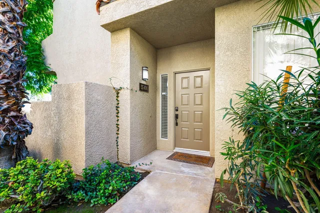 a living room with furniture and a refrigerator