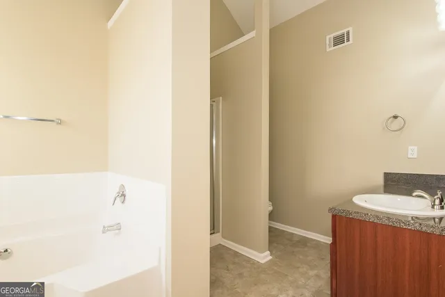 a bathroom with a bathtub and a sink
