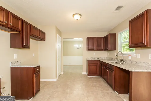 a kitchen with stainless steel appliances granite countertop a sink stove and cabinets