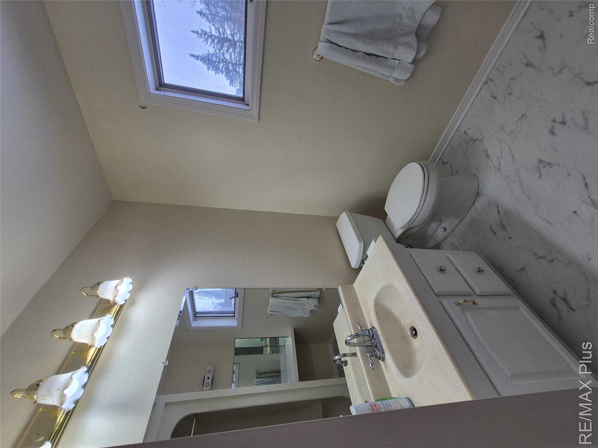 1115 Turrill Road Lapeer, MI 48446 - Photo 24 of 50 Bathroom featuring vanity and light marble finish flooring