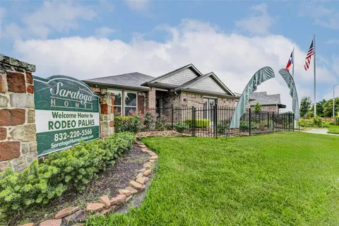 a view of a big house with a big yard and potted plants