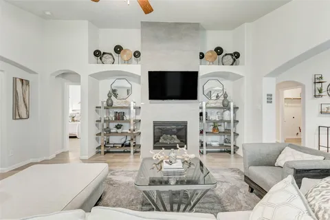 a living room with furniture a fireplace and a flat screen tv