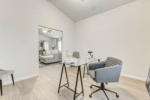 a living room with furniture and a chair