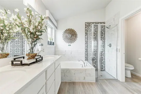 a kitchen with a sink and wooden floor