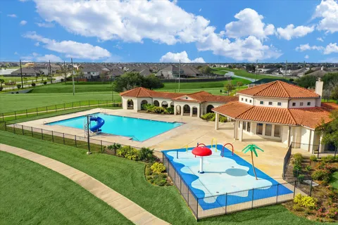 an aerial view of a house with swimming pool garden and outdoor seating