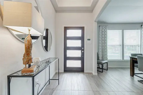 a kitchen with white cabinets and outdoor space